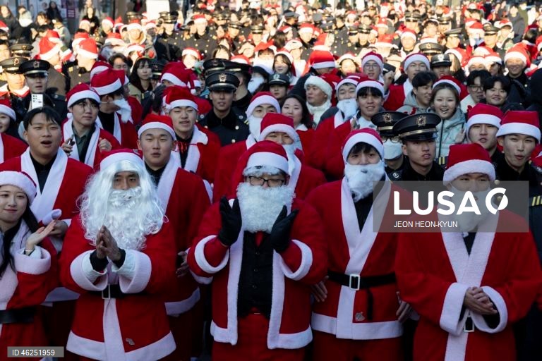 Voluntários sul-coreanos vestidos com trajes de Pai Natal participam de um evento beneficente na véspera de Natal em Seul, Coreia do Sul. A Fundação da Juventude da Coreia organizou o evento, distribuindo presentes a 1.004 crianças carentes.  