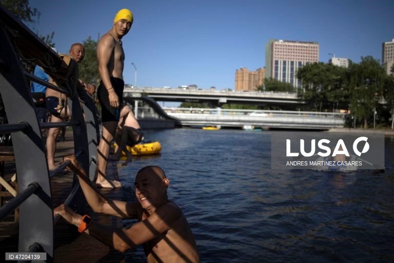 Pessoas utilizam barcos insufláveis e pranchas de remo no rio Liangma, em Pequim, China, a 30 de maio de 2026.  