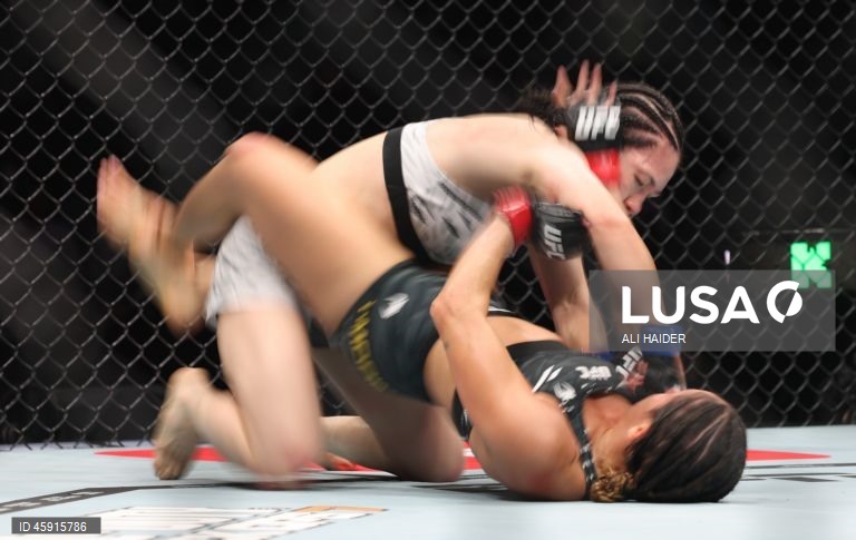 Jaqueline Amorim (vermelho) do Brasil e Mizuki Inoue (azul) do Japão em ação durante o UFC 321 na categoria peso palha feminino, em Abu Dhabi, Emirados Árabes Unidos.
